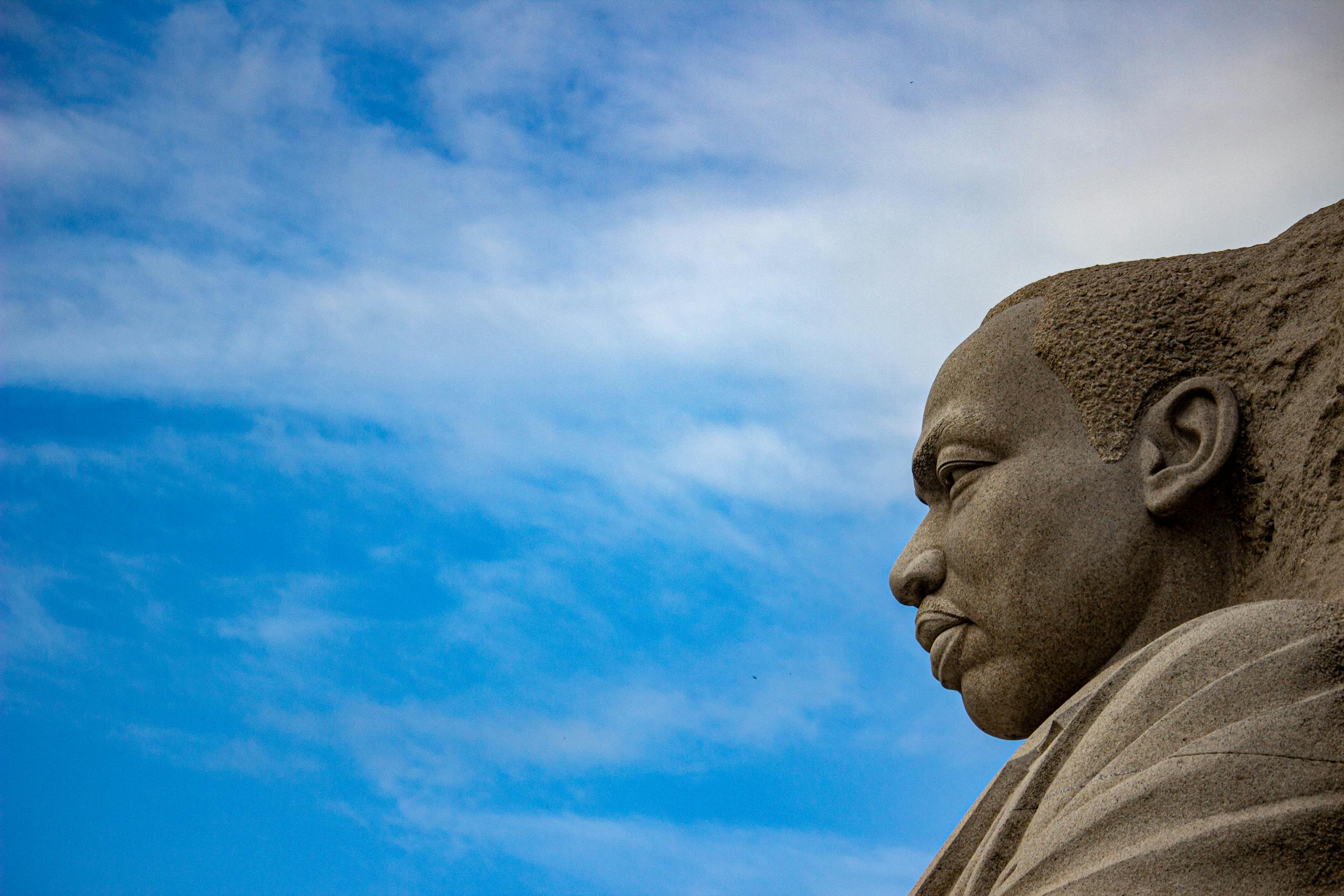 A striking view of the Martin Luther King Jr. Memorial against a blue sky in Washington D.C.