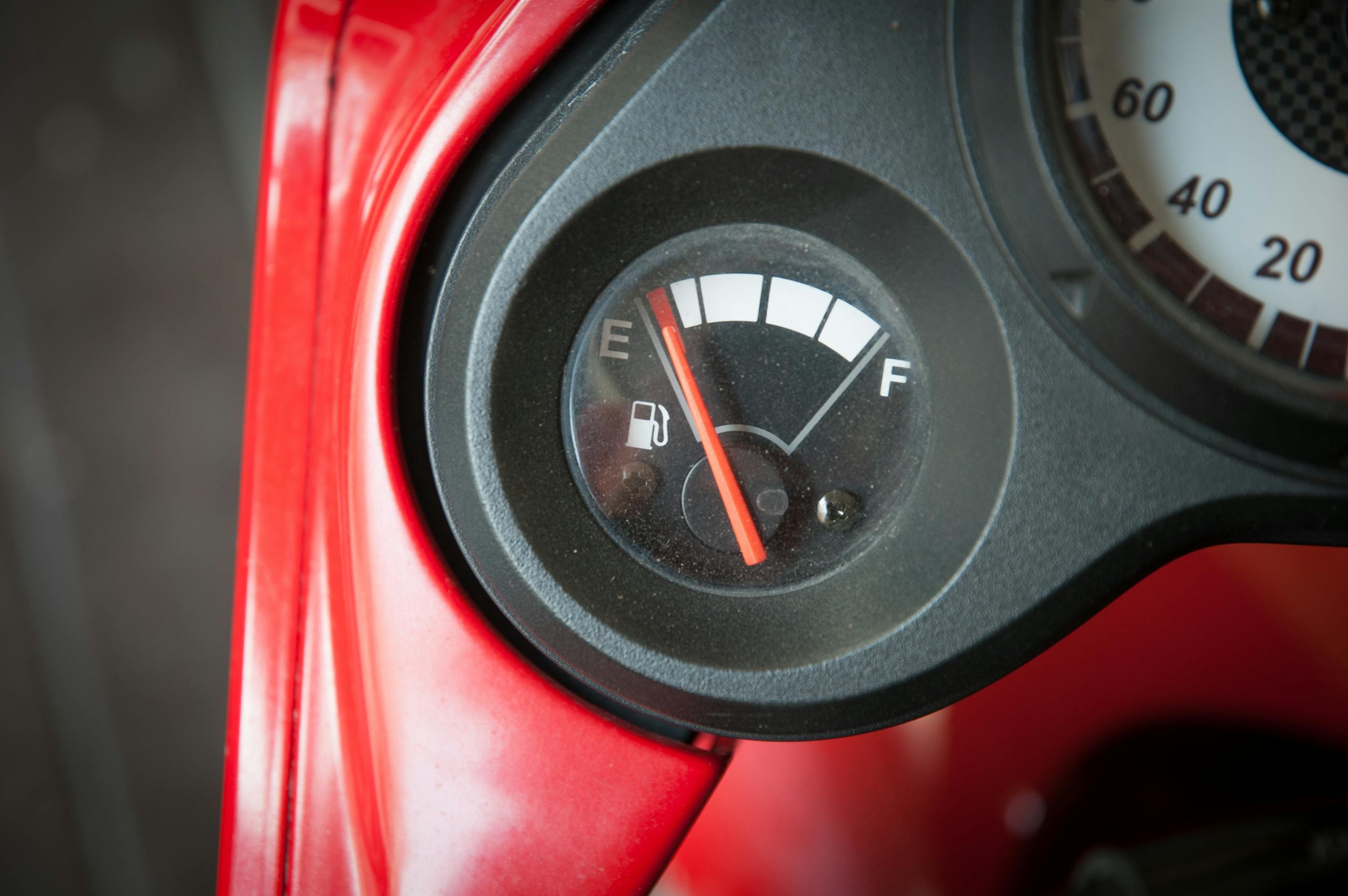 Close-up image of a car fuel gauge with the needle pointing to empty.